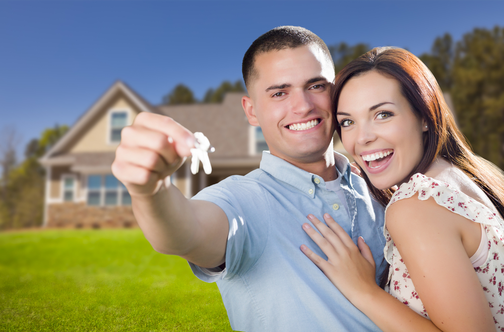 Couple holding keys to new home